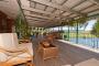 The expansive undercover timber deck with kitchen overlooking the Daintree River - Daintree Riverview Lodges