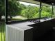 The kitchen on the deck overlooking the lush surrounding grounds - Daintree Riverview Lodges